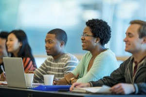 Diverse group of students at their computers, smiling